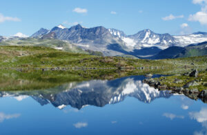 Reflection of mountain chain in a small lake in Jotunheimen national park in Norway.